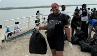 Volunteers collecting plastic waste by the water