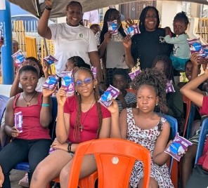 Girls holding sanitary kits at the Menstrual Health & Hygiene Project launch